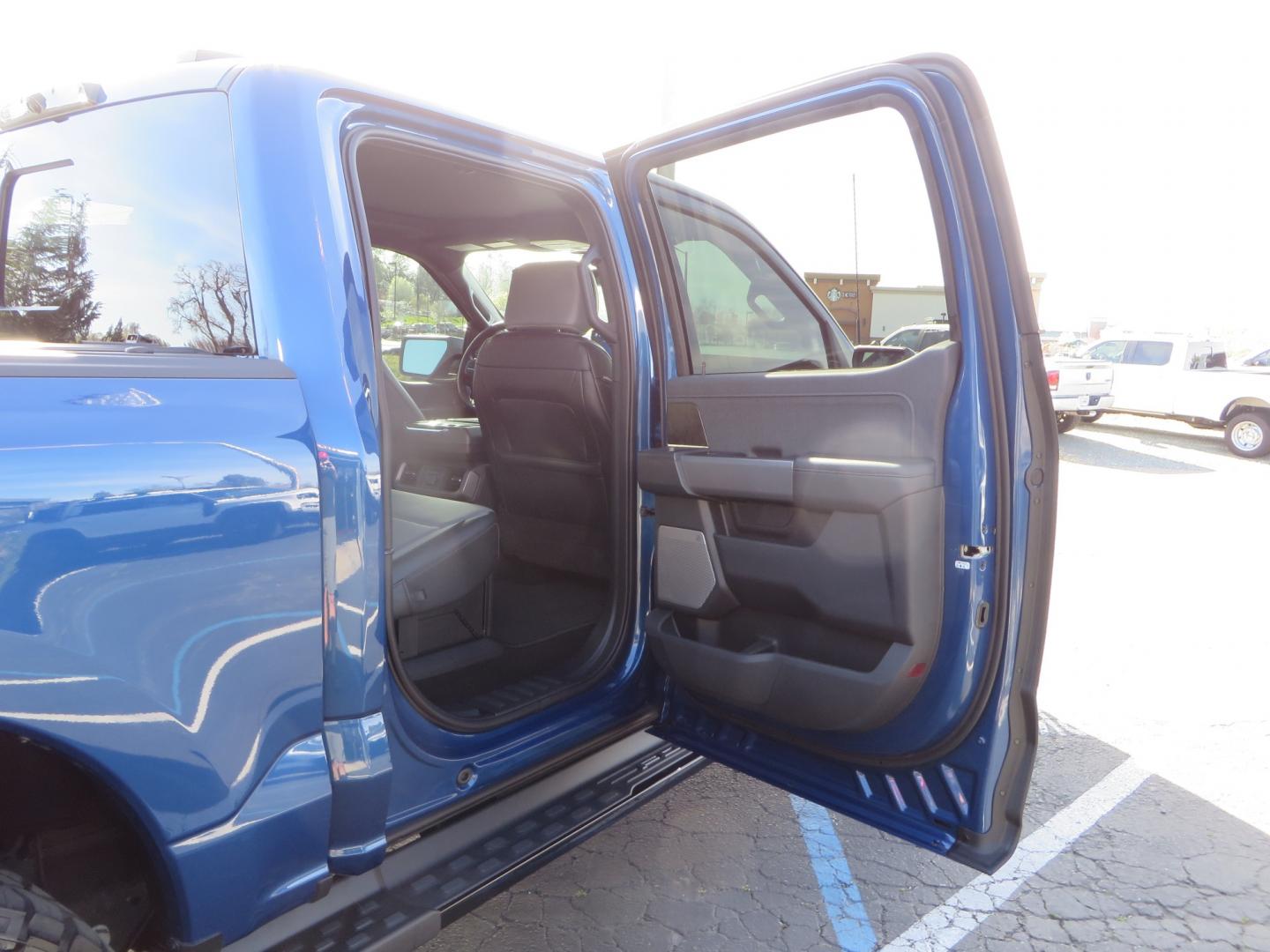 2022 BLUE /BLACK Ford F-150 Lariat Crew Cab 4WD (1FT6W1EV6NW) , located at 2630 Grass Valley Highway, Auburn, CA, 95603, (530) 508-5100, 38.937893, -121.095482 - Tired of gas prices and still want to look cool? Check out this Ford Lightning featuring a RC level kit, Nitto Ridge Grappler tires, Fuel Rebel wheels, Sinister front and rear bumpers, Baja Designs leds, Rigid Industries Leds, Bakflip F1, and window tint. - Photo#69